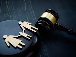 Family figures and court hammer. Family law and adoption concept.