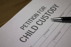 Someone filling out petition for child custody